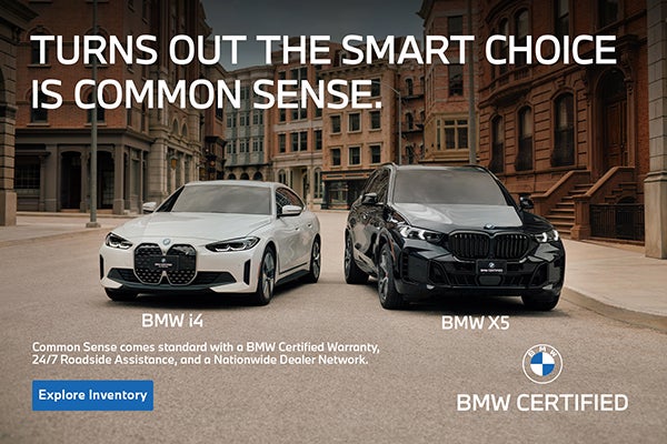 BMW i4 and BMW X5 parked on a city street . 